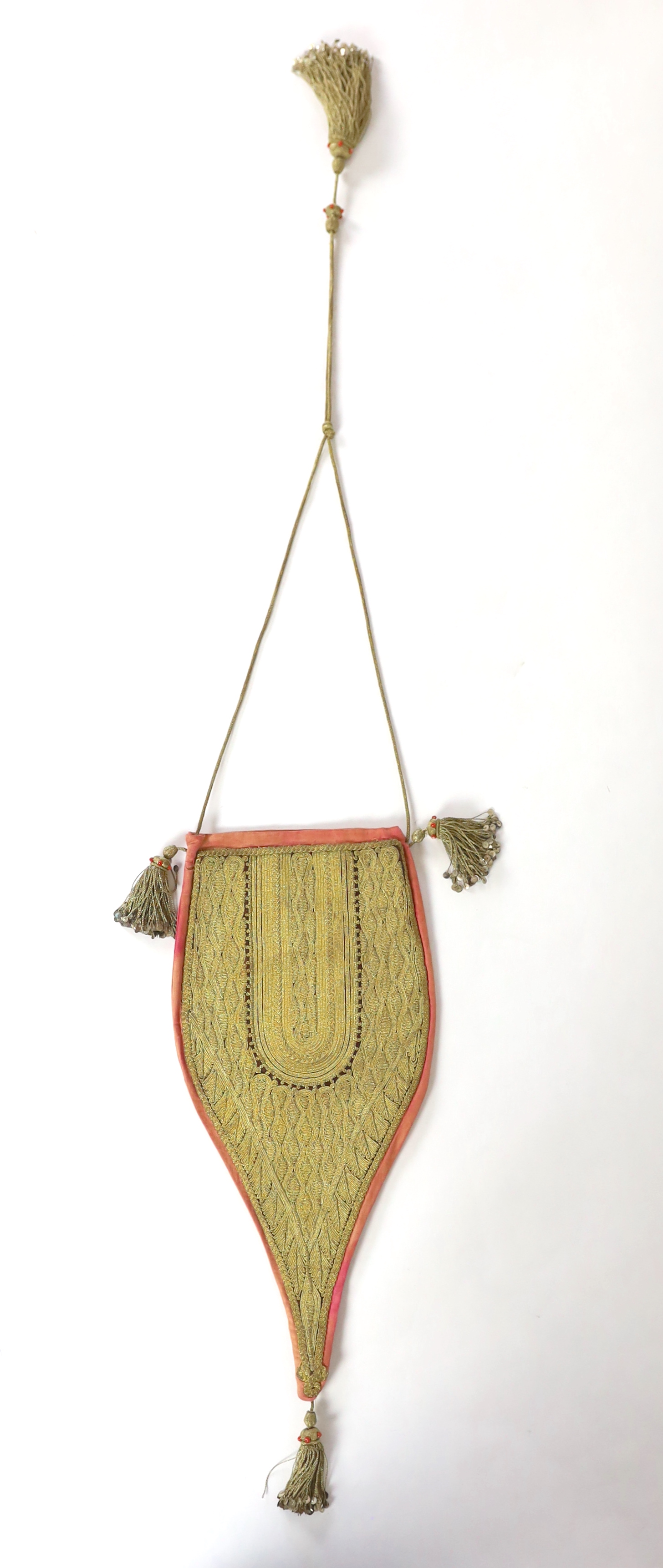 A heavily worked gold thread bag, probably Ottoman, 19th/20th century, with tassels and sequin and coral bead ornamentation, 38cm to end of tassel at base, 60cm strap / cord to end of tassel